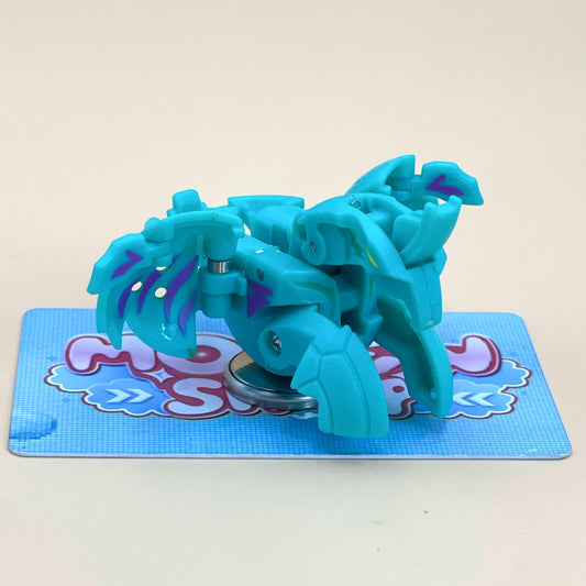 A blue toy with purple accents is sitting on a blue and white checkered surface.