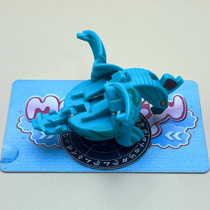 A blue toy figure is sitting on a blue and white checkered surface.