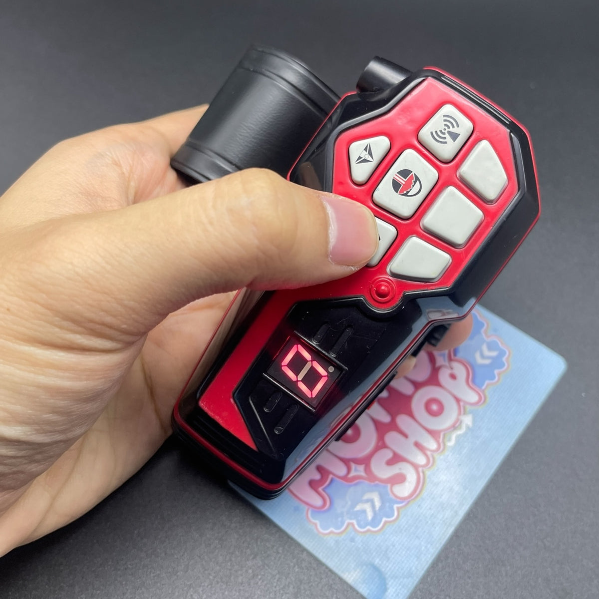 Hand holding Power Rangers Time Force Quantum Morpher with active red LED digital number display   