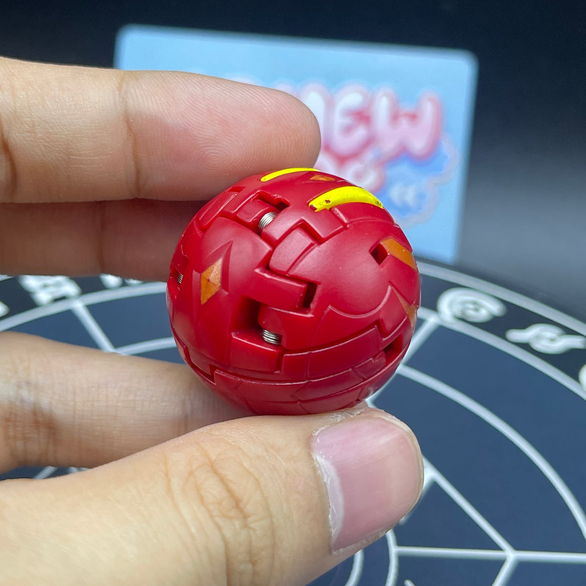 Close-up of Pyrus Neo Dragonoid in sphere form showing smooth red shell seams and compact design   