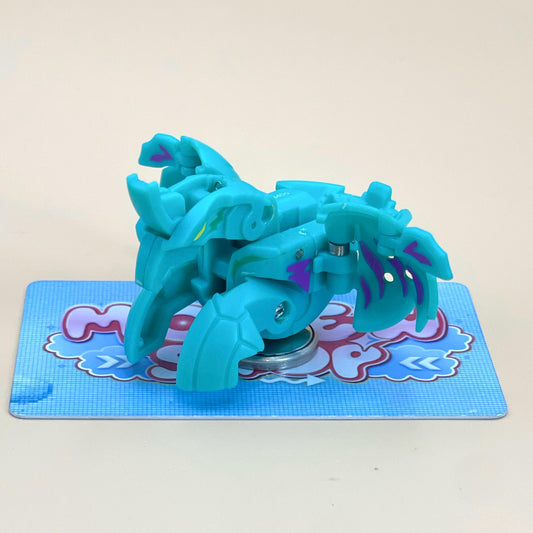 A blue toy with a purple and green design sits on a blue and white checkered surface.
