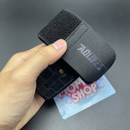 Hand holding black velcro strap assembly for Power Rangers Time Force Quantum Morpher   