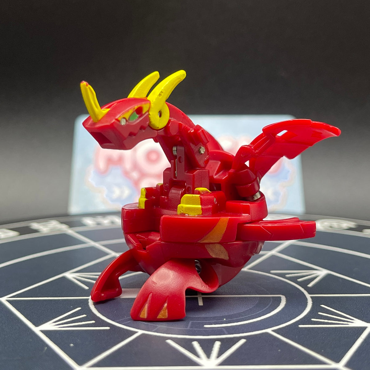 Authentic Pyrus Neo Dragonoid figure from Bakugan New Vestroia in dragon mode with red and yellow details on dark background   