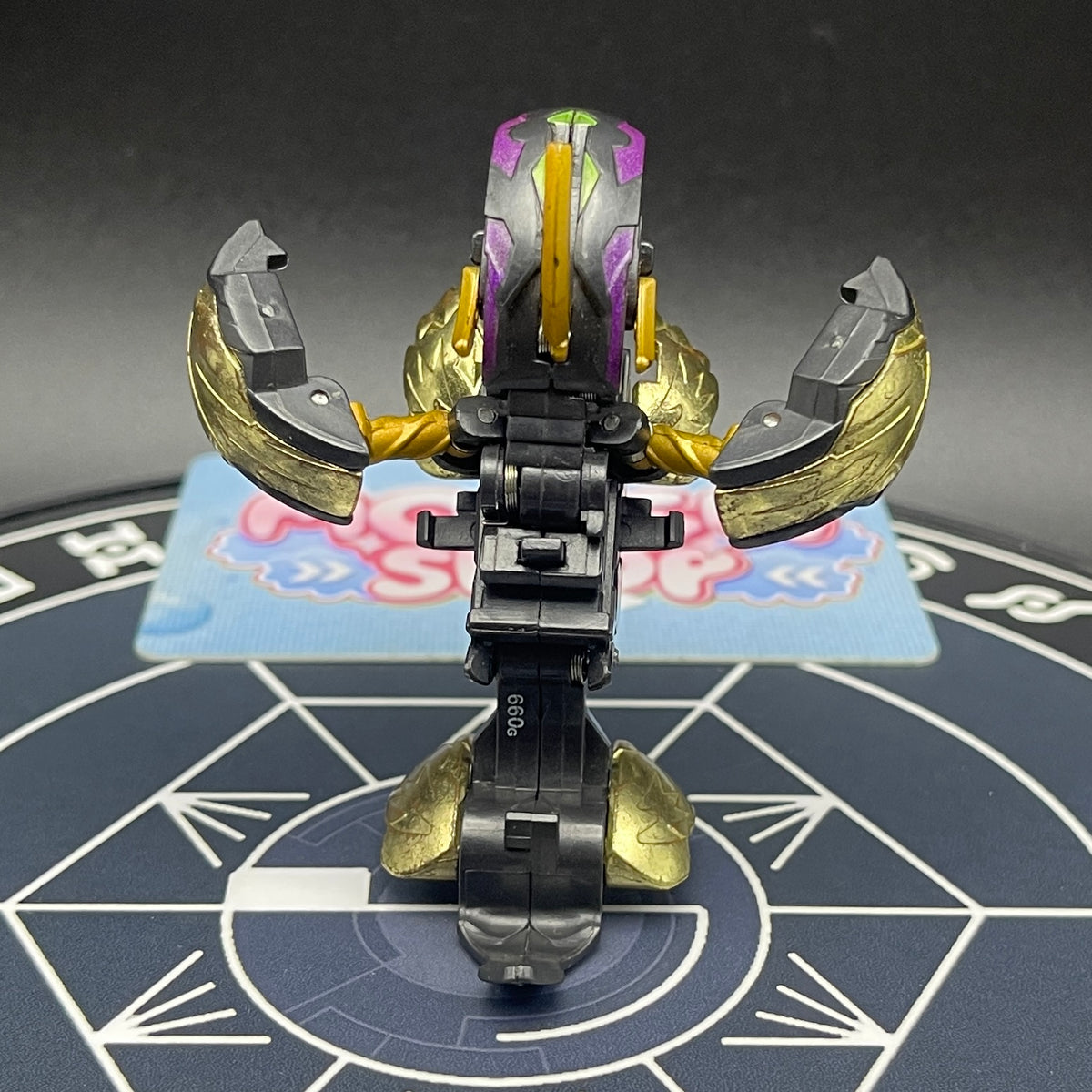 Back view of the opened Darkus Seis Tavanel Metal Cross Baku Tech Bakugan toy figure.