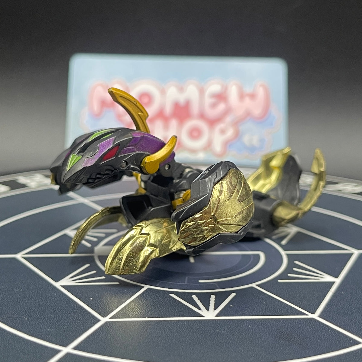 Side view of opened Darkus Seis Tavanel Metal Cross Baku Tech Bakugan showcasing its detailed armor parts.
