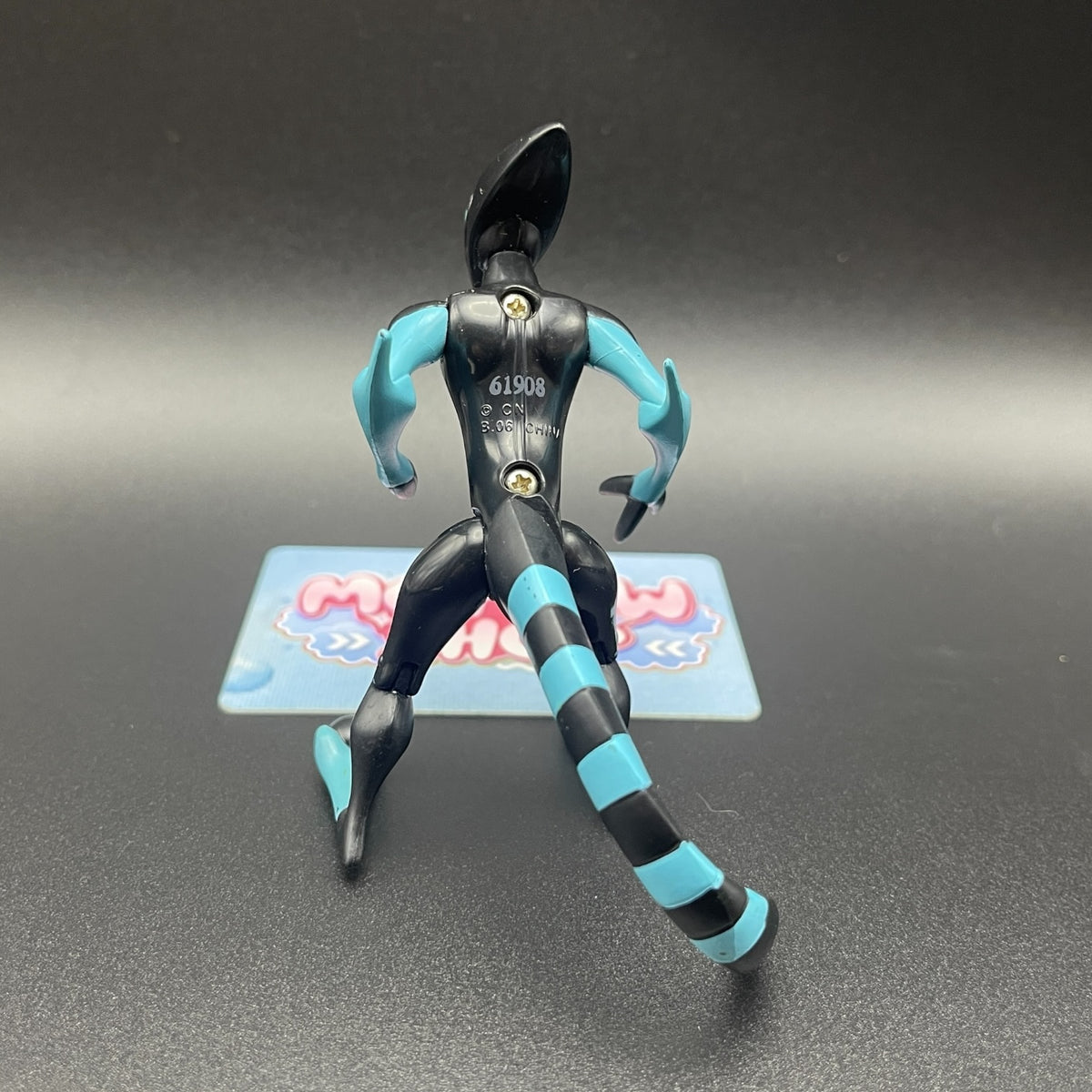 Back view of the Ben 10 Classic XLR8 action figure showing striped tail and wheel feet details.