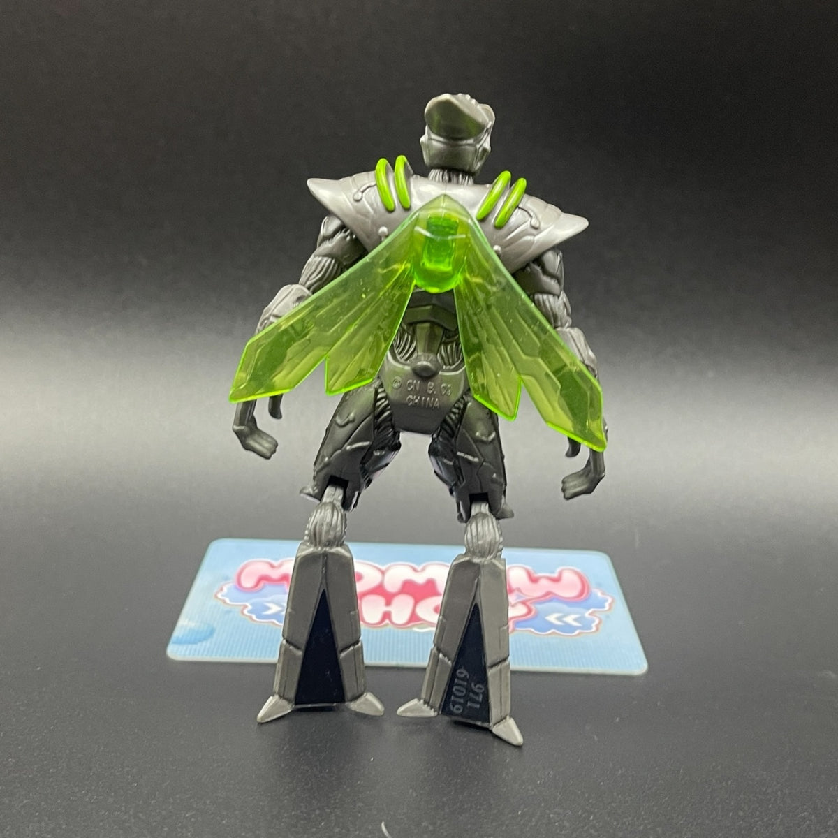 Back view of Nanomech action figure from Ben 10 Alien Swarm showing translucent green wings and detailed armor design.